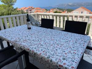 a bottle of wine sitting on a table on a balcony at Apartment Mama in Cavtat