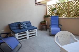 two chairs and a table on a patio at Casa Vacanze Lombardo in Santa Teresa di Riva