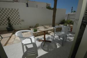 two chairs and a table on a patio at Pension Ocean View in Naxos Chora