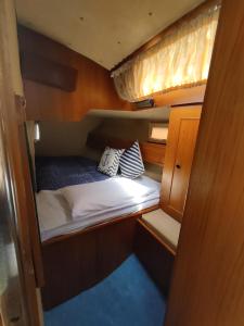 a small bed in the middle of a room at Dormire in Barca a Vela in Maratea