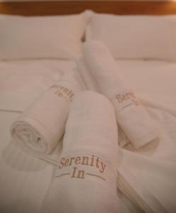 A bed or beds in a room at Serenity In