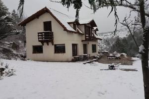 a house with snow in front of it at Casona Familiar en La Cumbrecita in La Cumbrecita