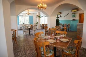 a dining room with tables and chairs and a chandelier at Crystal Suites in Amman