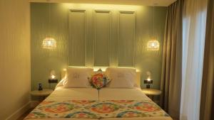 a bedroom with a bed with two pillows and two lights at La Puerta de Nerja BOUTIQUE - Adults Recommended in Nerja +48 photos