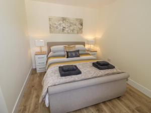 a bedroom with a bed with two towels on it at Garden Cottage in Worcester