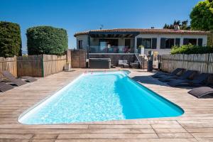 a swimming pool in front of a house at L'écrin de la Cité, Coeur de Vignes in Carcassonne