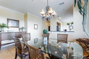 a dining room with a glass table and chairs at Cinnamon Beach Resort in Palm Coast