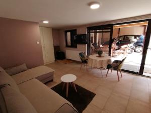 a living room with a couch and a table at Apartments Sofija in Niš