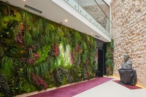 a wall covered in plants in a building at Marmont Heritage Hotel in Split