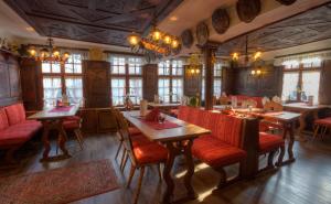 a restaurant with tables and red chairs and windows at Ferienwohnung am Markt in Monschau