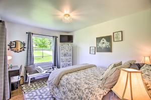 a bedroom with a bed and a desk and a window at Charming Country Cottage 5 Mi to Downtown Tulsa! in Tulsa
