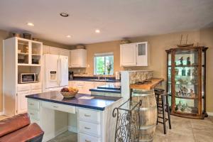 a kitchen with white cabinets and a counter top at Quaint Riverside Reprieve with Kayaks and Floats! in Brookings