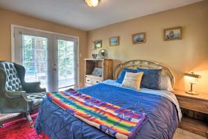 a bedroom with a bed and a chair and a window at Quaint Riverside Reprieve with Kayaks and Floats! in Brookings