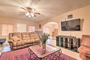 a living room with couches and a flat screen tv at Pet-Friendly Auburndale House with Lake Views! in Auburndale