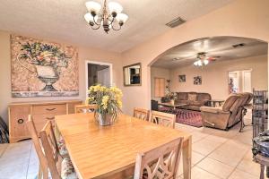 a dining room with a table and a living room at Pet-Friendly Auburndale House with Lake Views! in Auburndale