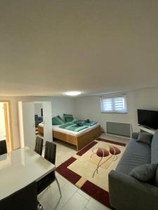 a living room with a couch and a bed at Özkurt-2 in Friedrichshafen