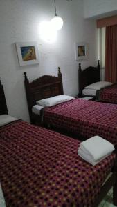 Un pat sau paturi într-o cameră la Hotel Atlântico Avenida