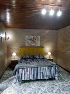 A bed or beds in a room at Casa do Rio - Lumiar