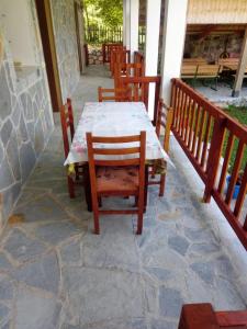 a table and chairs sitting on a patio at Buni Shqipes in Theth