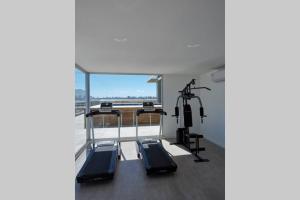 a gym with two tread machines and a large window at La Salina Apto a estrenar a pasos del puerto in Punta del Este