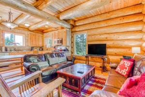 a living room with a couch and a tv at Skiing Bear Chalet in Government Camp