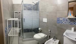 a bathroom with a shower and a toilet and a sink at B&B Pinulà in Maruggio +62 photos