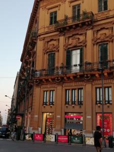 a building on the side of a street at suite ruggero settimo in Palermo +5 photos