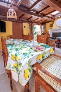 a dining room table with a table cloth with fruit on it at B&B BONE NOVELLE in LʼAquila