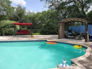 a swimming pool in a backyard with a gazebo at Hilltop Hacienda in San Marcos