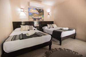 Postel nebo postele na pokoji v ubytování Hotel Macondo Holbox