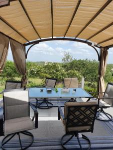 a table and chairs under a gazebo at Hilltop Hacienda in San Marcos