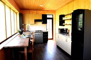 a kitchen with wooden cabinets and a wooden counter top at Gnishik Eco Resort in Gnishik