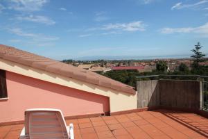 a chair sitting on the roof of a house at Gli Aranci Dell'Etna in Mascali