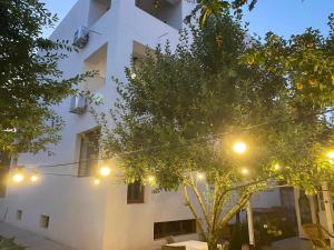 a white building with lights in front of it at DATIVO HOUSE in Mamaia Sat/Năvodari