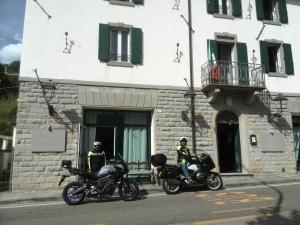 Locanda Michelacci في Corniolo: اثنين من الدراجات النارية متوقفة أمام المبنى