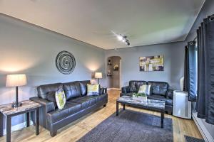 a living room with a leather couch and a table at Cozy Getaway 5 Miles to Duluth and Lake Superior! in Hermantown