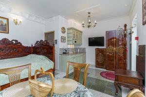 a bedroom with a bed and a table and chairs at Apartments near Old Town in Tallinn