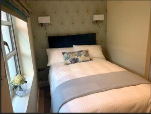 a bedroom with a bed with a pillow on it at Apartment, Kilkenny City in Kilkenny