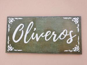 a sign that says cheers hanging on a wall at Premium Bed & Breakfast Casa Alegría Andaluza in Los Romanes