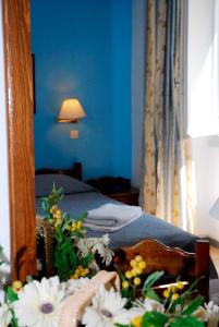 Katil atau katil-katil dalam bilik di Amaryllis Hotel
