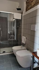 a bathroom with a tub and a toilet and a shower at “Sa Scala” Bed&Terrace in Baunei