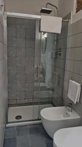 a bathroom with a shower and a toilet and a sink at “Sa Scala” Bed&Terrace in Baunei