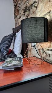 a table with a lamp and a book on it at “Sa Scala” Bed&Terrace in Baunei