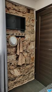 a stone wall with a tv on a wall at “Sa Scala” Bed&Terrace in Baunei