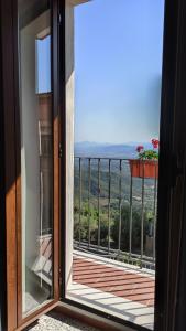 a view from a window of a balcony at “Sa Scala” Bed&Terrace in Baunei