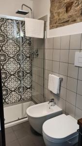 a bathroom with a toilet and a shower and a sink at “Sa Scala” Bed&Terrace in Baunei