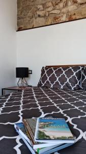 a bedroom with a bed with books on it at “Sa Scala” Bed&Terrace in Baunei