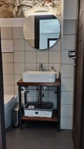 a bathroom with a sink and a mirror at “Sa Scala” Bed&Terrace in Baunei