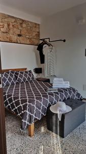 a bedroom with a black and white bed and a table at “Sa Scala” Bed&Terrace in Baunei