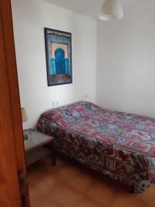 Un dormitorio con una cama y una mesa pequeña. en La Laja 13, en Playa Blanca